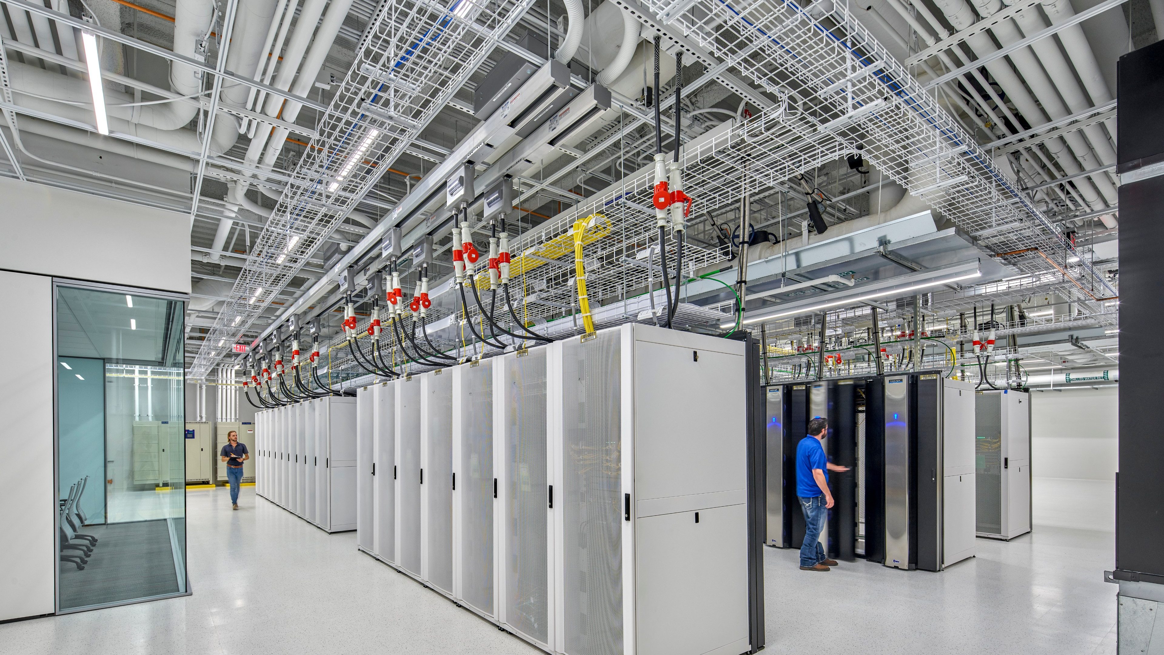 A man entering codes in a data centre